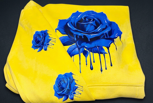 Yellow clothing with blue roses on a dark charcoal background